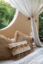 Open space bedroom with pillows on bedsheets and baldachin over bed