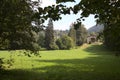 Open space in the mountain framed by trees with a house in the distance Royalty Free Stock Photo