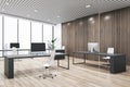 Open space office interior design with city view background from panoramic window, dark furniture and wooden slatted wall, modern Royalty Free Stock Photo