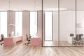Open space office, pink tables and meeting room