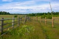 open space. wooden fences and green country field behind it. territory borders Royalty Free Stock Photo