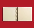 Open spiral bound agenda book on red background Royalty Free Stock Photo