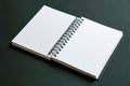 Open spiral-bound blank notebook with white clean pages displayed on dark surface ready for writing or drawing ideas and notes in Royalty Free Stock Photo