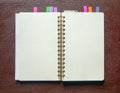 Open spiral bound notebook with blank pages and colorful bookmarkers Royalty Free Stock Photo