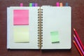 Open spiral bound notebook with  blank pages and post-it notes. Copy space Royalty Free Stock Photo