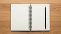 Open spiral-bound notebook placed on a wooden surface, displaying blank lined pages ready for Royalty Free Stock Photo
