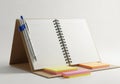 Open spiral notebook with pen and sticky notes isolated on white background Royalty Free Stock Photo