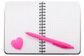 Open spiral squared notebook with ballpoint pen and heart shaped Royalty Free Stock Photo