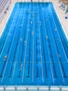 The open sports swimming pool glistened under the bright sun as people swimming in its inviting waters.