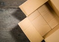 Open square cardboard box on the background of the old wooden table.