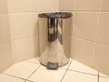 Open stainless steel bucket for garbage in the toilet. Garbage container in the bathroom at home or in the office. Metal trash can