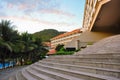 Open stone staircase to a palm garden with a swimming pool under the rays of the dawn sun Royalty Free Stock Photo