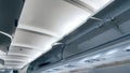Open storage arae for bags under the ceiling at passsenger airplane Royalty Free Stock Photo