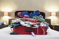 Open suitcase on bed Royalty Free Stock Photo