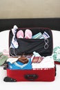 Open suitcase on bed elevated view Royalty Free Stock Photo