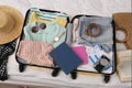Open suitcase with clothes and accessories on bed, flat lay Royalty Free Stock Photo