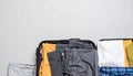 Open suitcase with folded clothes and blank background space Royalty Free Stock Photo