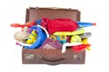 Open suitcase full of summer vacation