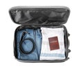 Open suitcase with packed things on white background, top view Royalty Free Stock Photo