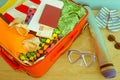 Open suitcase packed for travelling, close up. Suitcase with different things prepared for travel Royalty Free Stock Photo
