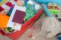 Open suitcase packed for travelling, close up. Suitcase with different things prepared for travel Royalty Free Stock Photo