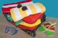 Open suitcase packed for travelling, close up. Suitcase with different things prepared for travel Royalty Free Stock Photo