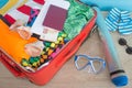 Open suitcase packed for travelling, close up. Suitcase with different things prepared for travel Royalty Free Stock Photo