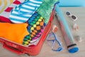 Open suitcase packed for travelling. Suitcase with different things prepared for travel Royalty Free Stock Photo