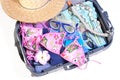 Open suitcase with vacation items