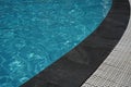Open swimming pool bord, water and black marble texture.