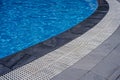 Open swimming pool bord, water and black marble texture.