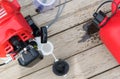 Open tank and lawn mowing equipment lie on a light background close up Royalty Free Stock Photo