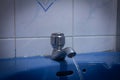 An open tap with water flowing in wash basin Royalty Free Stock Photo