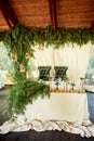 Open terrace in the village style. Catering in a wooden manzanda. Wedding, decor paws ate. Green velvet armchairs.