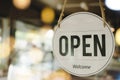 Open text on vintage sign board hanging on glass door with bokeh light Royalty Free Stock Photo