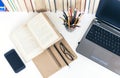 Open textbook, notebook, smartphone, laptop computer, stack of books education back to school background, glasses and pencils in Royalty Free Stock Photo