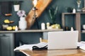 Open textbook with pen, laptop, stack of uncovered books and cup of coffee on table at home office Royalty Free Stock Photo