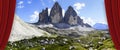 Open theater red curtains against the Tre Cime di Lavaredo panoramic view in summer - Dolomitics landscapes (Italy)