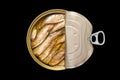 Open tin can of smoked sprats in oil, isolated on black background. Top view, flat lay Royalty Free Stock Photo