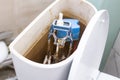 open toilet cistern when flush system breaks down, dirty poorly paid plumbing job Royalty Free Stock Photo