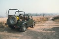 Open-top car on the field road. Competition off road and rough terrain. The Safari vehicles on the background of autumn road and t Royalty Free Stock Photo