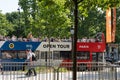 Open tour bus with french flag colors in Paris. Visitors on the roof top of sightseeing bus at sunny day. Paris - France, 31. may