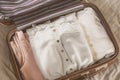 Open traveler`s bag with clothing, accessories and passport Royalty Free Stock Photo