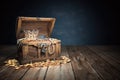 Open treasure chest filled with golden coins, gold  and jewelry Royalty Free Stock Photo