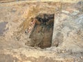 Trench with small diameter pipe and heap of ground near Royalty Free Stock Photo