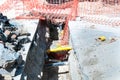 Open trench on the street excavation site with visible pipes for water gas and heating system. Royalty Free Stock Photo