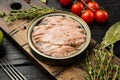 Open tuna tin, on black wooden table background