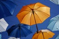 Open umbrellas as a sun canopy on a city street on a clear sunny day