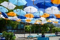 Open umbrellas as a sun canopy on a city street on a clear sunny day Royalty Free Stock Photo