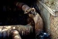 An open underground pipeline with valves in a brick well Royalty Free Stock Photo